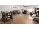 Open-concept living room with wood-look tile floors, comfortable seating, and dining area at 12043 N 46Th Ave, Glendale, AZ 85304