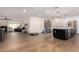 Spacious living area connecting to kitchen, showcasing modern tile flooring and stainless steel refrigerator at 12043 N 46Th Ave, Glendale, AZ 85304