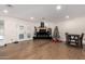 Bright living room with painted brick fireplace, Christmas decorations, and wood-look tile floors at 12043 N 46Th Ave, Glendale, AZ 85304
