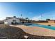Backyard featuring a pool, a covered patio, a dining area, and low-maintenance landscaping at 12043 N 46Th Ave, Glendale, AZ 85304