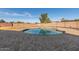 Backyard view featuring a refreshing pool, a patio, and well-maintained desert landscaping at 12043 N 46Th Ave, Glendale, AZ 85304