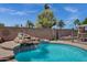 Inviting backyard features a rock waterfall feature enhancing the lush greenery and serene pool at 1245 W Cindy St, Chandler, AZ 85224