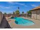 Backyard pool with a rock waterfall, landscaping, and privacy walls, creating a tropical getaway at 1245 W Cindy St, Chandler, AZ 85224