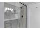 Modern bathroom with frameless glass shower, marble-look walls, and modern fixtures for an elegant spa-like experience at 1245 W Cindy St, Chandler, AZ 85224