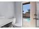 Powder room with backyard pool view, contemporary fixtures, and clean design for easy access from the patio at 1245 W Cindy St, Chandler, AZ 85224