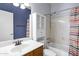 Bathroom with white vanity sink, built in shelves, and combination tub and shower at 1245 W Cindy St, Chandler, AZ 85224