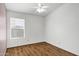Neutral bedroom with wood-look floors, ceiling fan, and window with blinds at 1245 W Cindy St, Chandler, AZ 85224