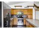 Well-lit kitchen featuring stainless steel appliances, wooden cabinetry and decorative backsplash at 1245 W Cindy St, Chandler, AZ 85224