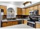 Bright kitchen features stainless steel appliances, granite counters, and arched window at 1245 W Cindy St, Chandler, AZ 85224