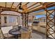 Outdoor seating area featuring a ceiling fan, dining table, built-in grill, and brick flooring at 1245 W Cindy St, Chandler, AZ 85224