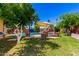 Lush backyard featuring a swimming pool, charming chicken coop, and ample green space at 125 E Loma Ln, Phoenix, AZ 85020