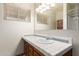 Bathroom sink and countertop with natural light from a window, complementing the classic tile and wood vanity at 125 E Loma Ln, Phoenix, AZ 85020