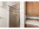 Modern bathroom shower with glass door, white tile, and decorative trim, offering a clean and stylish design at 125 E Loma Ln, Phoenix, AZ 85020