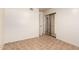 Spacious bedroom with tile flooring and mirrored closet doors, offering a bright and airy feel at 125 E Loma Ln, Phoenix, AZ 85020