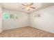 Bedroom featuring tile flooring, neutral walls, and bright natural light from the windows at 125 E Loma Ln, Phoenix, AZ 85020