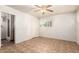 Bedroom with tile flooring and an ensuite bathroom with a glass shower door at 125 E Loma Ln, Phoenix, AZ 85020
