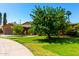 Lovely brick home with well-maintained lawn and mature trees adding to the curb appeal at 125 E Loma Ln, Phoenix, AZ 85020