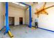 Unique garage with car lift, stylish epoxy floors, and decor, perfect for car enthusiasts and hobbies at 125 E Loma Ln, Phoenix, AZ 85020