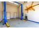 Unique garage with car lift, stylish epoxy floors, and decor, perfect for car enthusiasts and hobbies at 125 E Loma Ln, Phoenix, AZ 85020