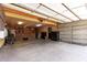 Spacious garage with organized storage, brick accents, and ample room for vehicles and projects at 125 E Loma Ln, Phoenix, AZ 85020