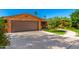 Brick home featuring a spacious two-car garage and a beautifully landscaped front yard at 125 E Loma Ln, Phoenix, AZ 85020
