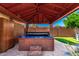 Relaxing hot tub area with privacy enclosure and lush landscaping for ultimate relaxation at 125 E Loma Ln, Phoenix, AZ 85020