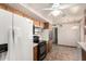 Kitchen showcasing wood cabinets, tile countertops and a white refrigerator at 125 E Loma Ln, Phoenix, AZ 85020