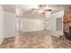 Large living room with tile flooring, a ceiling fan, and easy access to other rooms at 125 E Loma Ln, Phoenix, AZ 85020