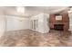 Open living room featuring tile flooring, a brick fireplace, and French doors at 125 E Loma Ln, Phoenix, AZ 85020