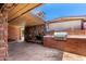 An outdoor kitchen with a built-in grill and fireplace, perfect for entertaining friends and Gathering at 125 E Loma Ln, Phoenix, AZ 85020