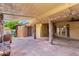 Inviting covered patio with stone pillars, ceiling fan, and French doors, ideal for outdoor entertaining at 125 E Loma Ln, Phoenix, AZ 85020