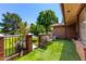 Inviting front patio with artificial grass, decorative fencing, seating, and a charming gate at 125 E Loma Ln, Phoenix, AZ 85020