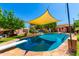 Beautifully landscaped backyard featuring a sparkling pool, diving board, and shaded seating area at 125 E Loma Ln, Phoenix, AZ 85020