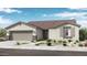 Charming single-story home featuring stone accents, a two-car garage, and desert-friendly landscaping at 14323 W Alameda Rd, Surprise, AZ 85387