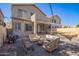 Inviting backyard with a fire pit, cozy seating, string lights, and low-maintenance gravel, perfect for outdoor enjoyment at 1451 E South Fork Dr, Phoenix, AZ 85048