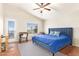Bright bedroom features a door to the patio, a ceiling fan, and an exterior view at 1451 E South Fork Dr, Phoenix, AZ 85048