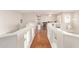 A bright hallway features wood floors and white wainscoting providing access to other areas of the house at 1451 E South Fork Dr, Phoenix, AZ 85048