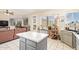 Modern kitchen with island, stainless steel appliances and ample natural light and a connecting Living Room at 1451 E South Fork Dr, Phoenix, AZ 85048