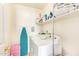 This utility room is equipped with a washer, dryer, and shelving for storage at 1451 E South Fork Dr, Phoenix, AZ 85048