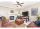 Cozy living room featuring a fireplace, comfortable furniture, and tile flooring at 1451 E South Fork Dr, Phoenix, AZ 85048