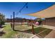 Enclosed backyard play area, a sunshade, a swing set, and green grass at 1585 E Jeanne Ln, San Tan Valley, AZ 85140