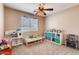 Bright bedroom with carpet, a ceiling fan, and a window displaying toys and play furniture at 1585 E Jeanne Ln, San Tan Valley, AZ 85140