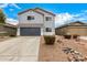 Two-story home featuring a gray stucco exterior, a red tile roof, and a two-car garage at 1585 E Jeanne Ln, San Tan Valley, AZ 85140