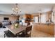 Open-concept kitchen with wooden cabinets, stainless steel appliances, and dining area at 1585 E Jeanne Ln, San Tan Valley, AZ 85140