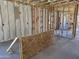 Interior framing with insulation, electrical, and plumbing, showcasing construction phase at 18224 W La Senda Dr, Surprise, AZ 85387