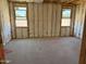 Bedroom framing with insulation, highlighting the windows and layout at 18224 W La Senda Dr, Surprise, AZ 85387