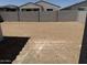 A flat, empty backyard, ready for landscaping at 18240 W La Senda Dr, Surprise, AZ 85387