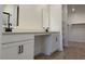 Bathroom with double sink vanity, white cabinets and wood-look flooring at 18240 W La Senda Dr, Surprise, AZ 85387