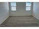 Bedroom with neutral carpet and large windows for ample natural light at 18240 W La Senda Dr, Surprise, AZ 85387