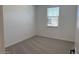 Clean, carpeted bedroom features a window that provides natural light at 18240 W La Senda Dr, Surprise, AZ 85387